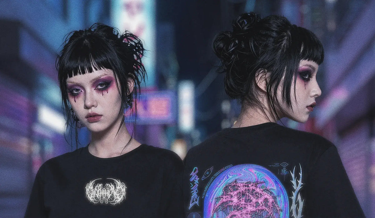 Front and back view of a black oversized graphic tee with metal-style chest logo and holographic planet print on the back, modeled in a neon-lit city street