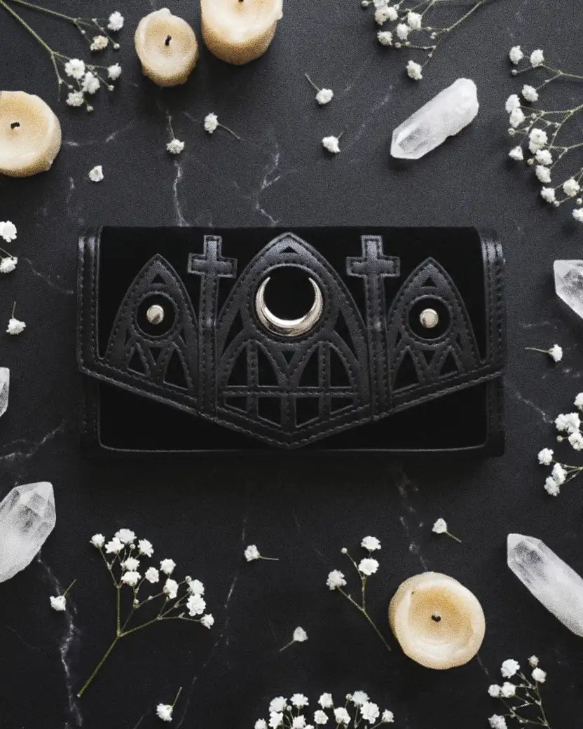 Banned Alternative Femme Fatale wallet on marble counter with esoteric decor details.