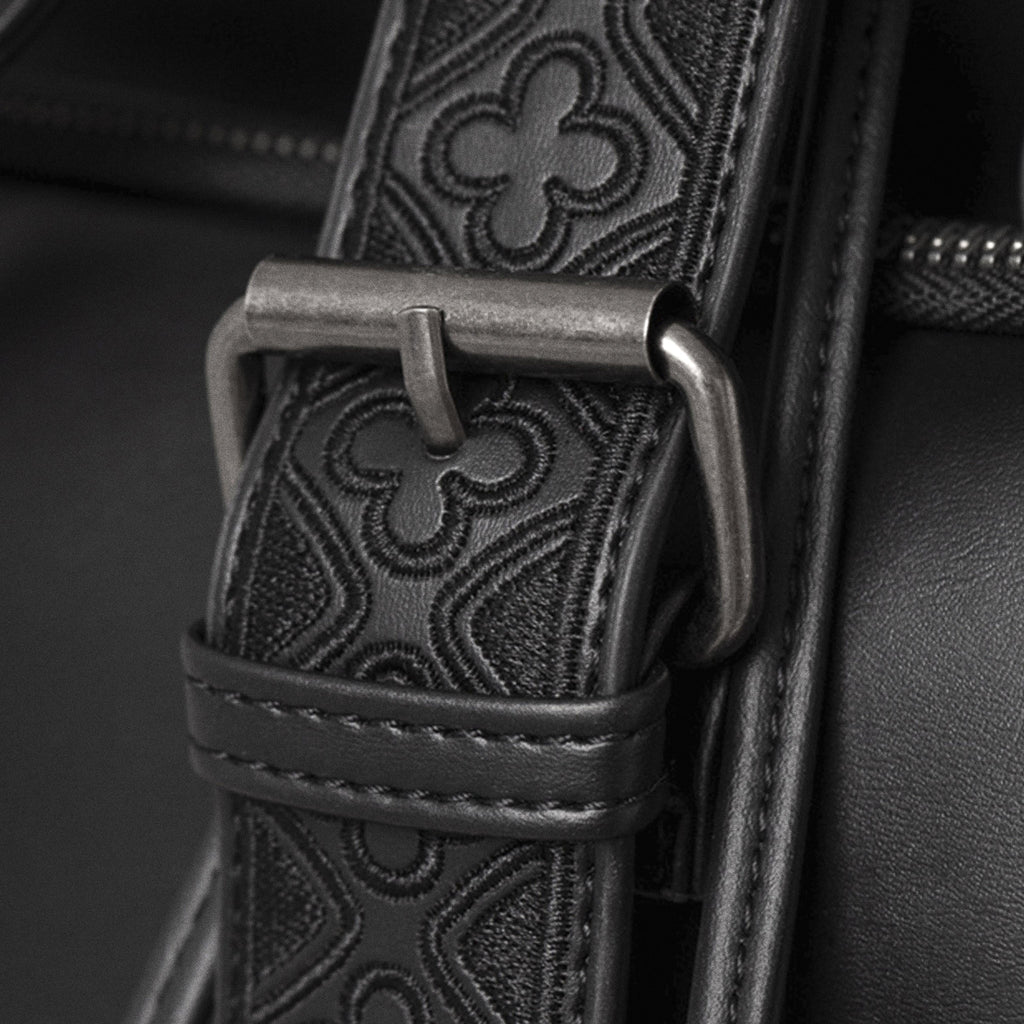 Mochila con solapa en forma de serpiente bordada con motivos inspirados en las catedrales vista detalle hebilla