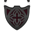Bolso bandolera negro con diseño rígido en forma de escudo inspirado en las catedrales y la arquitectura medieval con detalles en terciopelo burdeos modelo Claretia de Restyle vista frontal
