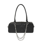  Elongated gothic shoulder bag with an embossed skull and a decorative silver chain