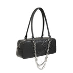  Angled view of the black gothic bag with embossed skull and hanging chain