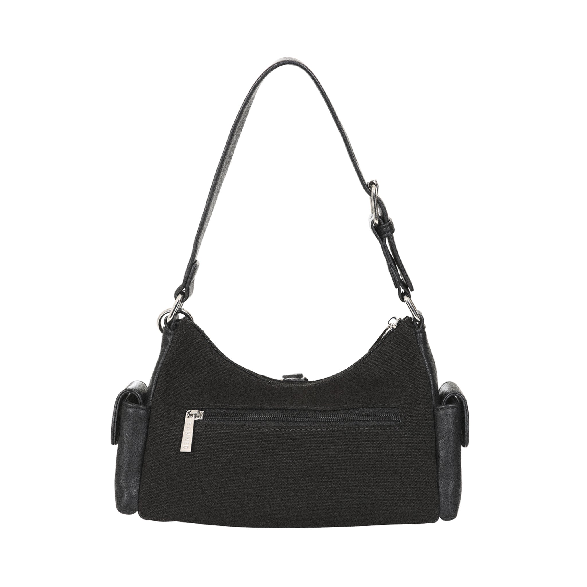 Vista trasera del bolso gótico Y2K, mostrando el cuerpo de lona y el bolsillo exterior con cremallera.