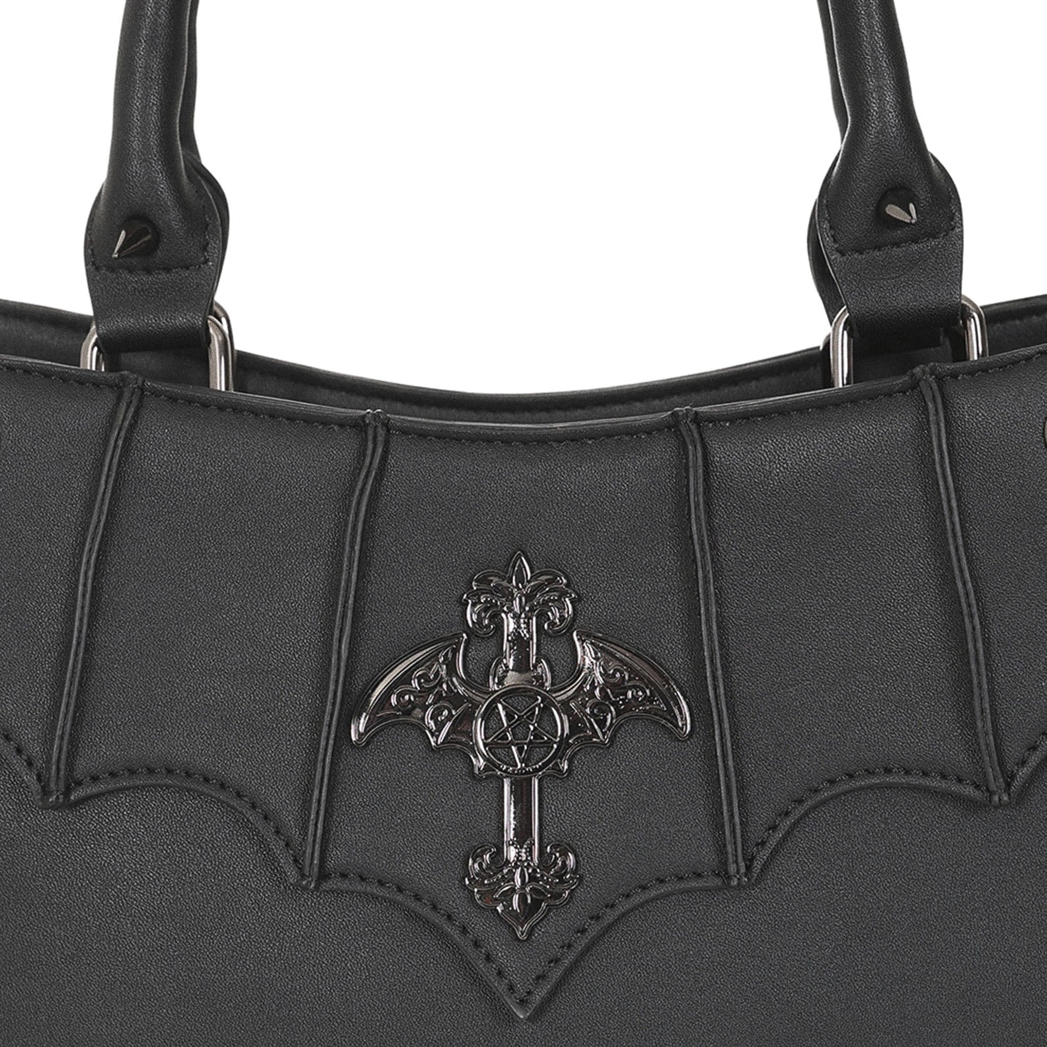  Close-up of the metal ornament: a cross with bat wings and a pentagram center