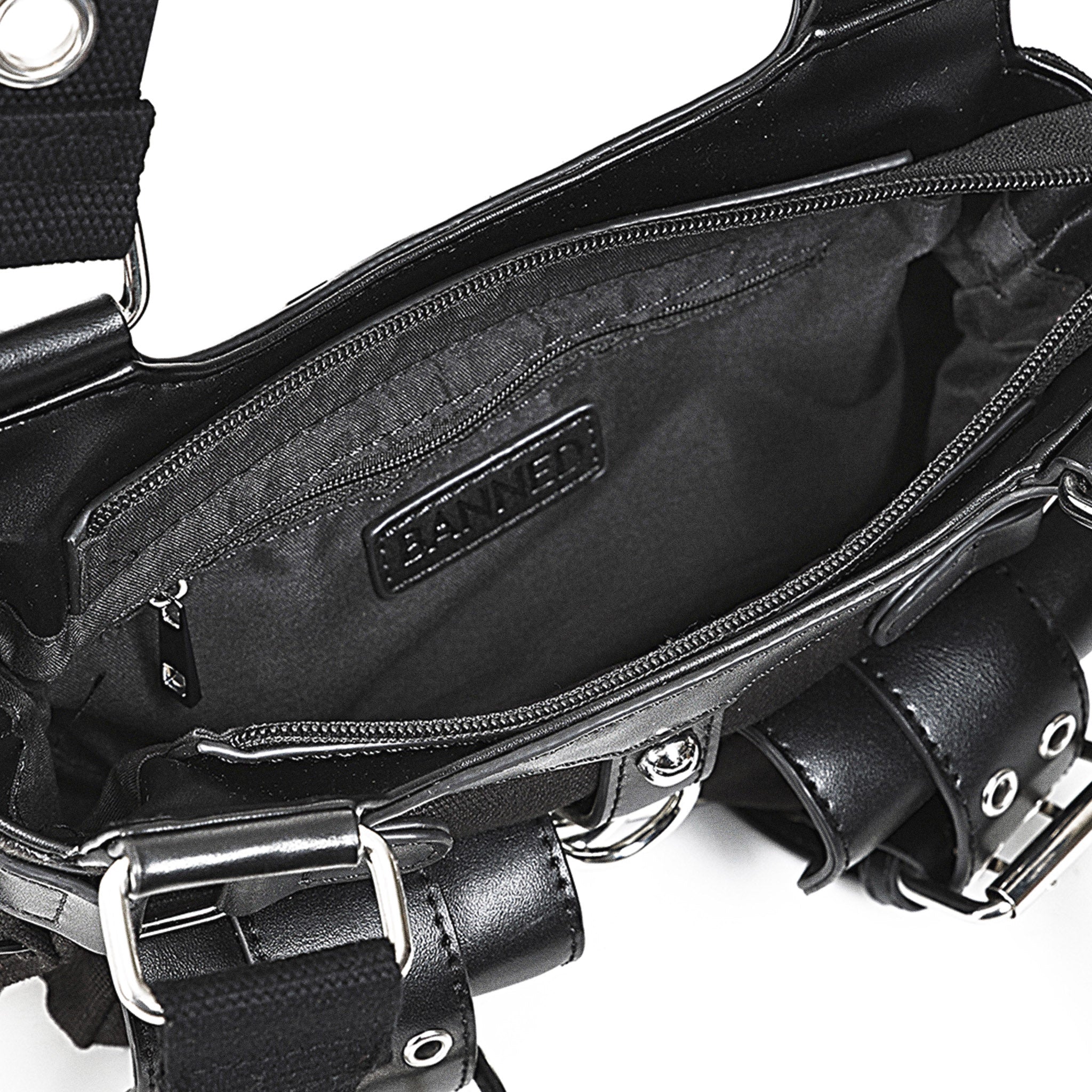 Interior del bolso mostrando el bolsillo con cremallera y los dos compartimentos abiertos.