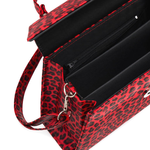 Interior del bolso Stardust Rumbler abierto, mostrando el forro negro, tres compartimentos y un bolsillo central con cremallera.