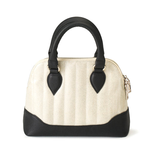 Bolso Pin-Up blanco y negro, mostrando las asas negras y la costura vertical de la tela.