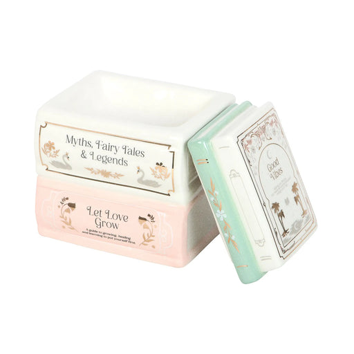 Quemador de aceites esenciales y cera en forma de libros apilados estilo fairy aesthetic vista sin tapa sobre fondo blanco.