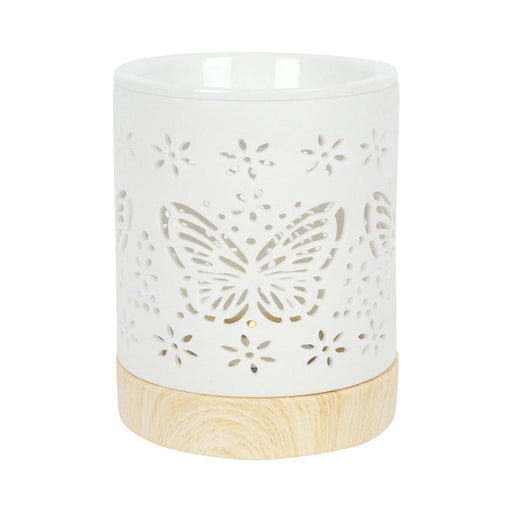 Quemador de aceites esenciales y calentador de cera con diseño de mariposa calada en blanco y base de madera vista frontal sobre fondo blanco.