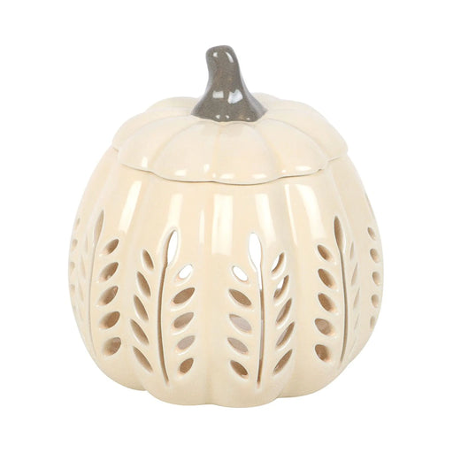 Quemador de aceites esenciales y calentador de cera con diseño en forma de calabaza calada en tonos crema vista frontal sobre fondo blanco.
