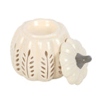 Quemador de aceites esenciales y calentador de cera con diseño en forma de calabaza calada en tonos crema vista sobre fondo blanco con tapa abierta.