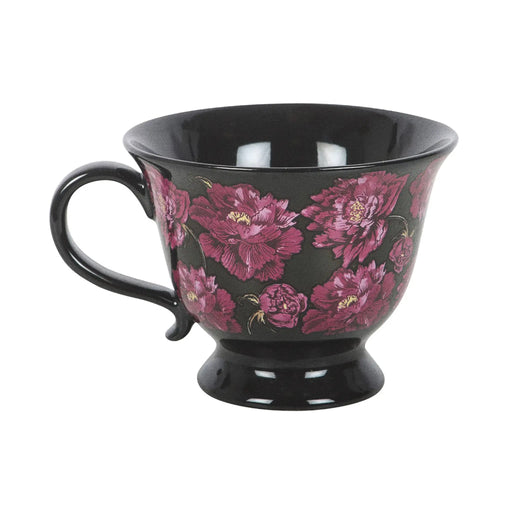 Taza negra de estética dark romance en negro con flores en color púrpura vista de taza y asa sobre fondo blanco.