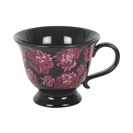 Taza negra de estética dark romance en negro con flores en color púrpura vista de taza y asa sobre fondo blanco.