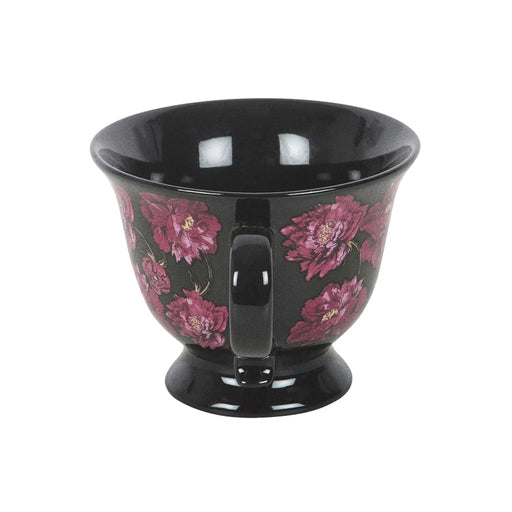 Taza negra de estética dark romance en negro con flores en color púrpura vista de taza y asa de lado sobre fondo blanco.