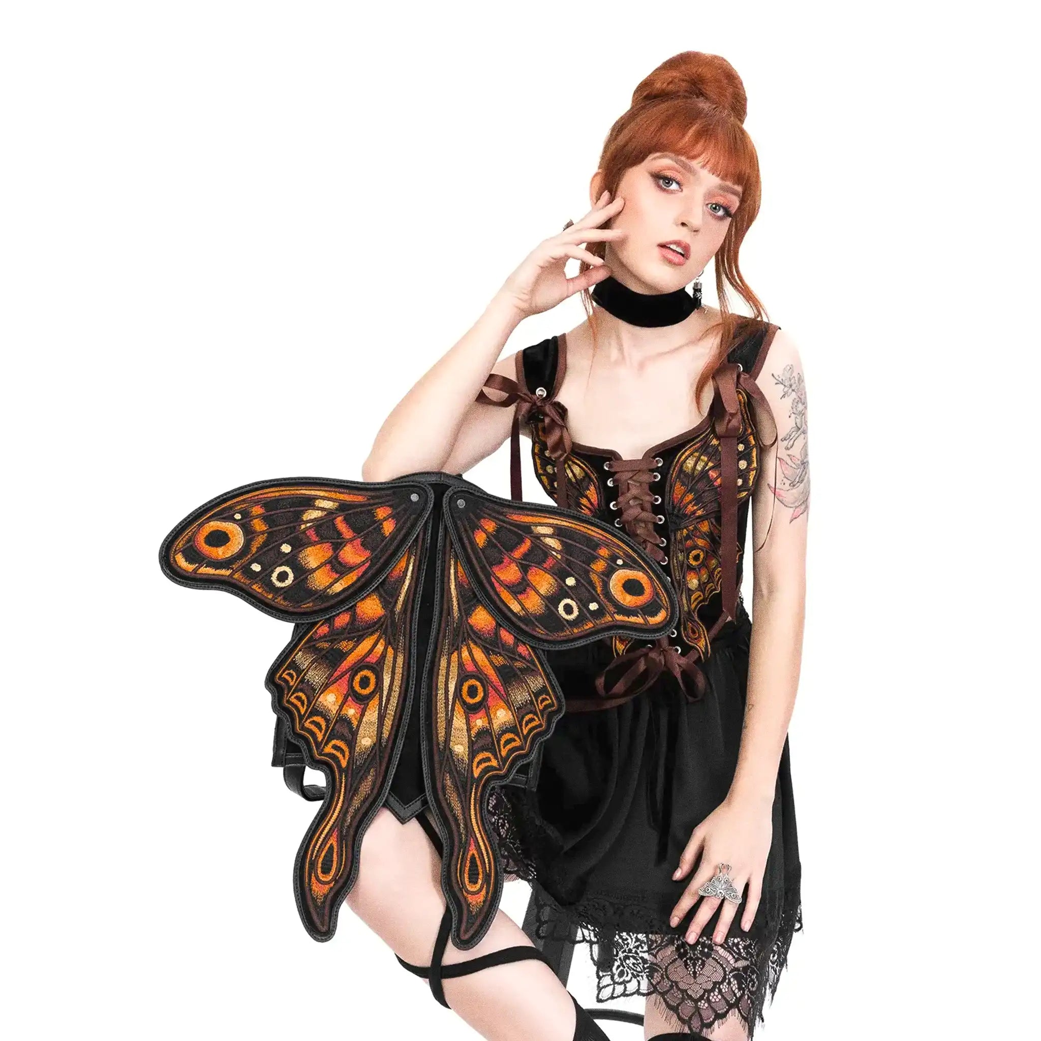 Mochila con forma de polilla y alas móviles con impresionante bordado en tonos fuego fabricada en tejido vegano vista con alas abiertas con modelo