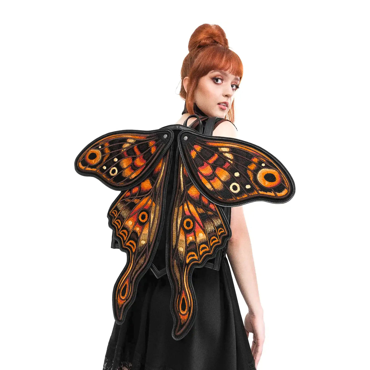 Mochila con forma de polilla y alas móviles con impresionante bordado en tonos fuego fabricada en tejido vegano vista con alas abiertas en modelo