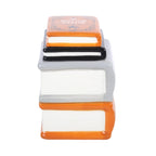 Quemador de aceite y calentador de ceras aromáticas en forma de libros apilados de estética de Halloween y Spooky en naranja, negro y gris vista lateral de los libros sobre fondo blanco.