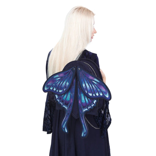 Mochila con alas bordadas en forma de polilla con capacidad de cambiar de posición en tonos azules y violetas estilo whimsigoth y fairycore modelo Sapphire Moth de Restyle vista en hombro de modelo