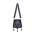 Bolso rígido en azul medianoche con ribetes en negro, bordado en tonos plateados con un diseño celestial de polilla, luna, estrellas y vegetación estilo whimsigoth. Borlas decorativas en la solapa. Vista frontal completa con correa