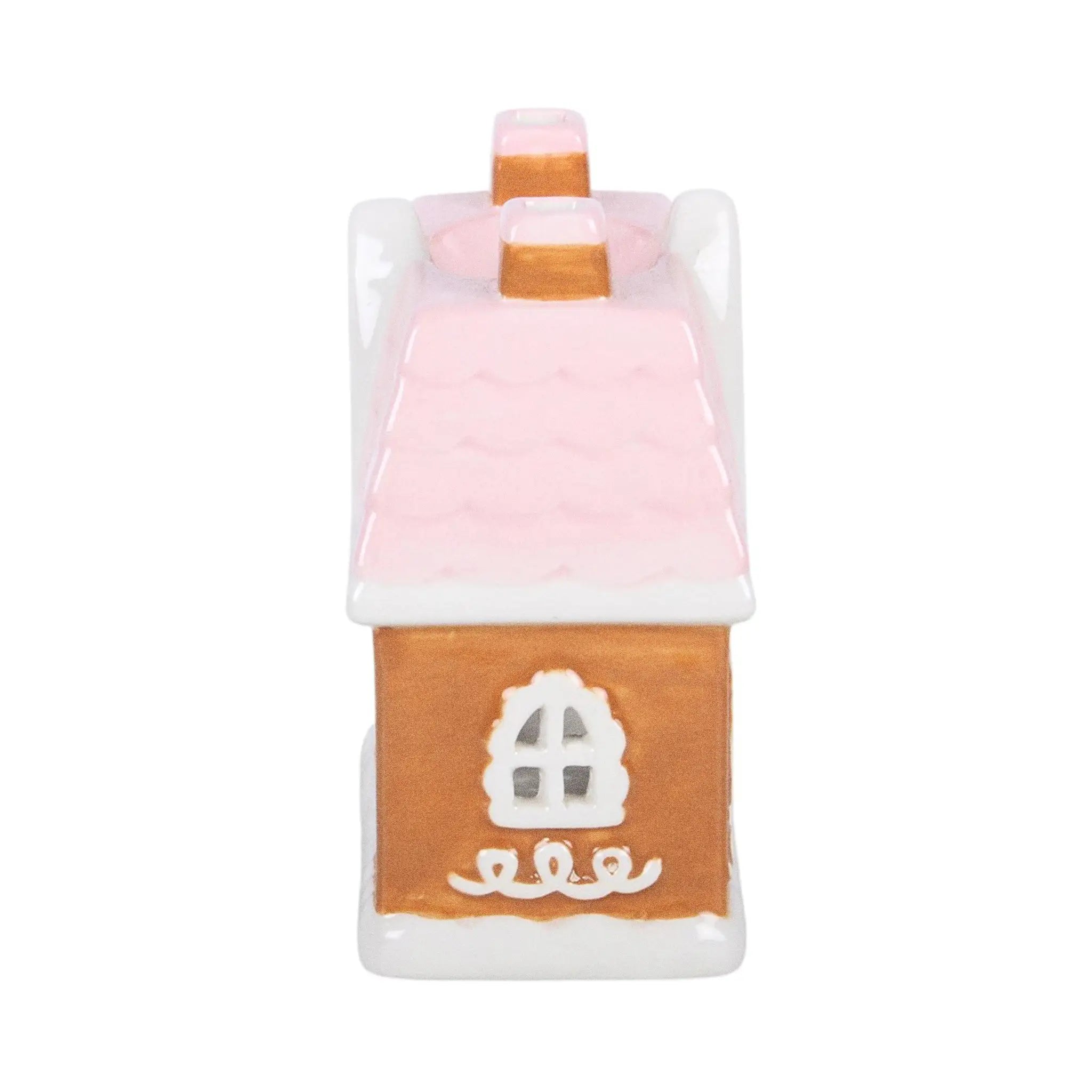 Quemador de aceite y calentador de cera en forma de casita de jengibre estilo navideño en marrón, blanco y rosa vista lateral casita sobre fondo blanco.