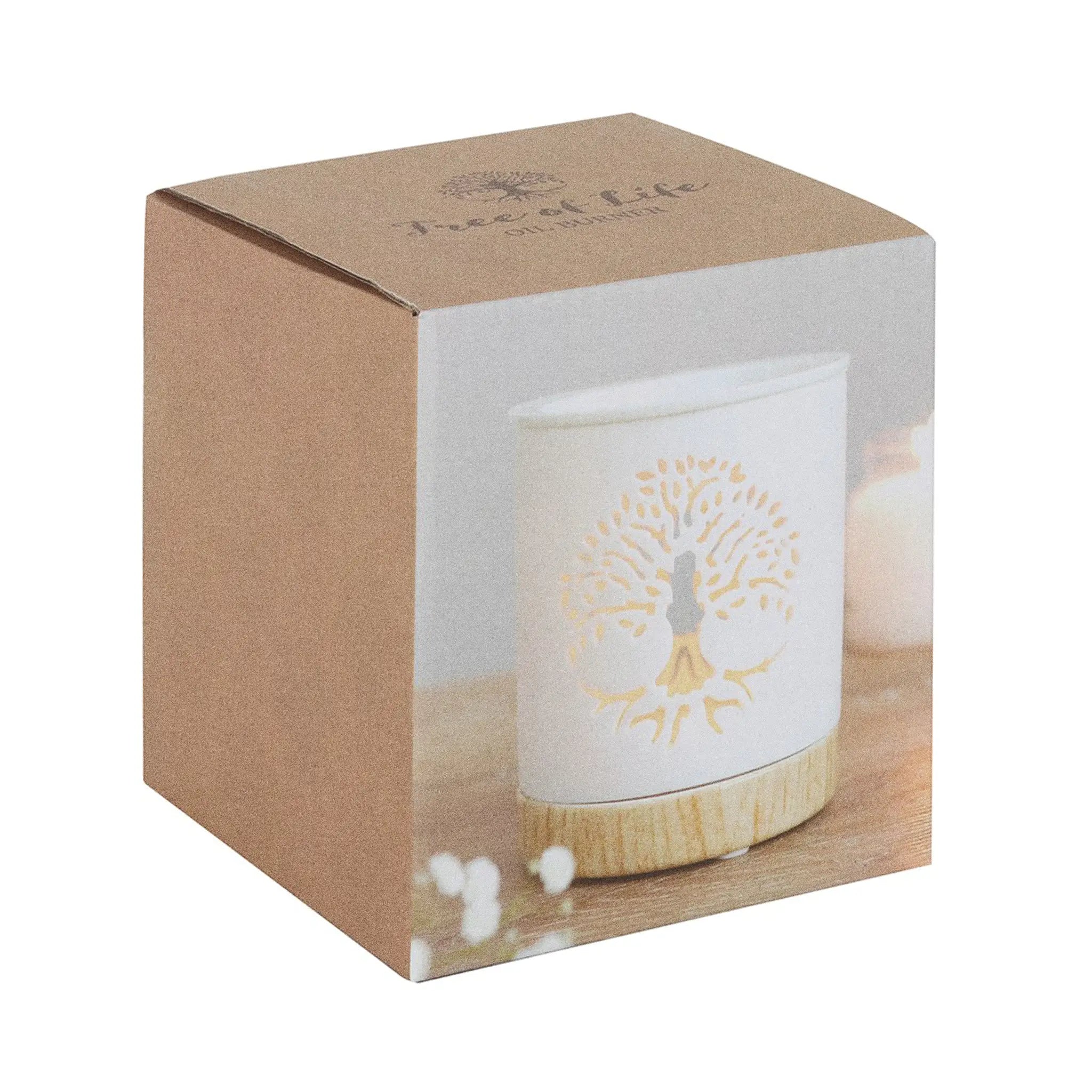 Quemador de aceites esenciales y calentador de cera con diseño de árbol de la vida calado sobre cerámica y base de madera vista packaging sobre fondo blanco.