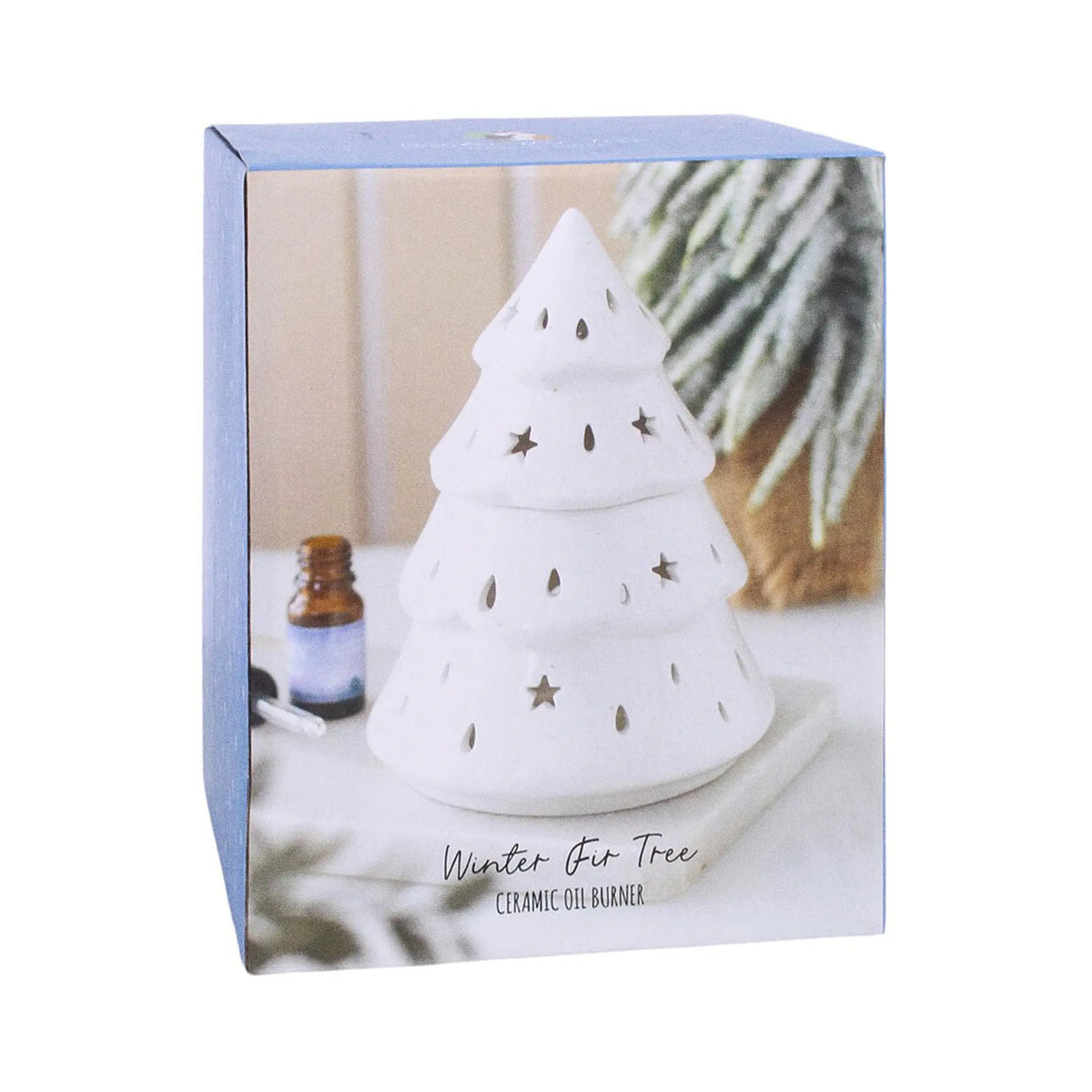 Quemador de aceites esenciales con forma de árbol de navidad y estrellas y gotas cut out en la superficie vista packaging sobre fondo blanco.